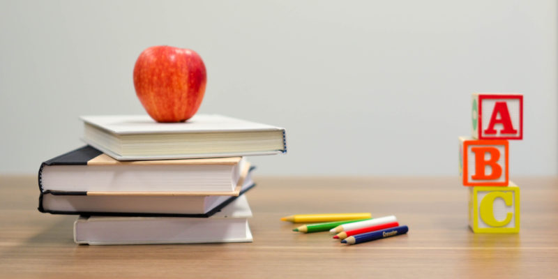 Books and apple representing gifted and talented education